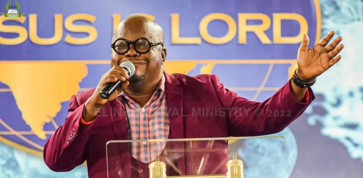 A preacher speaking at a lectern with a microphone